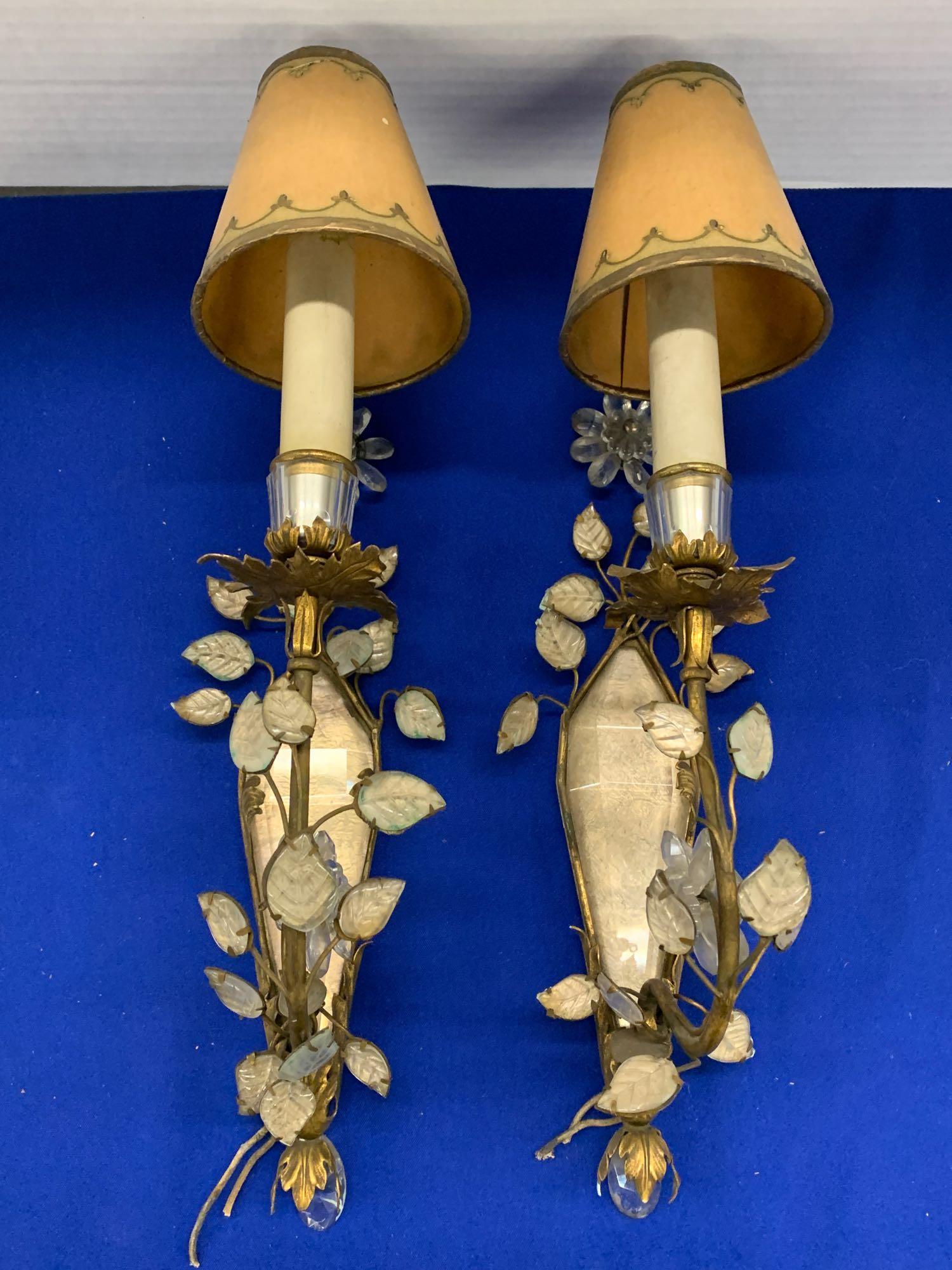 Pr. Bagues-style Gilt Metal and Crystal Sconces: A pair of wall sconces by or in the style of Maison Bagues, with foliate frames and glass leaf vine design, with central crystal mounts, and each with one electrified light. Height: 17in to tops of sh