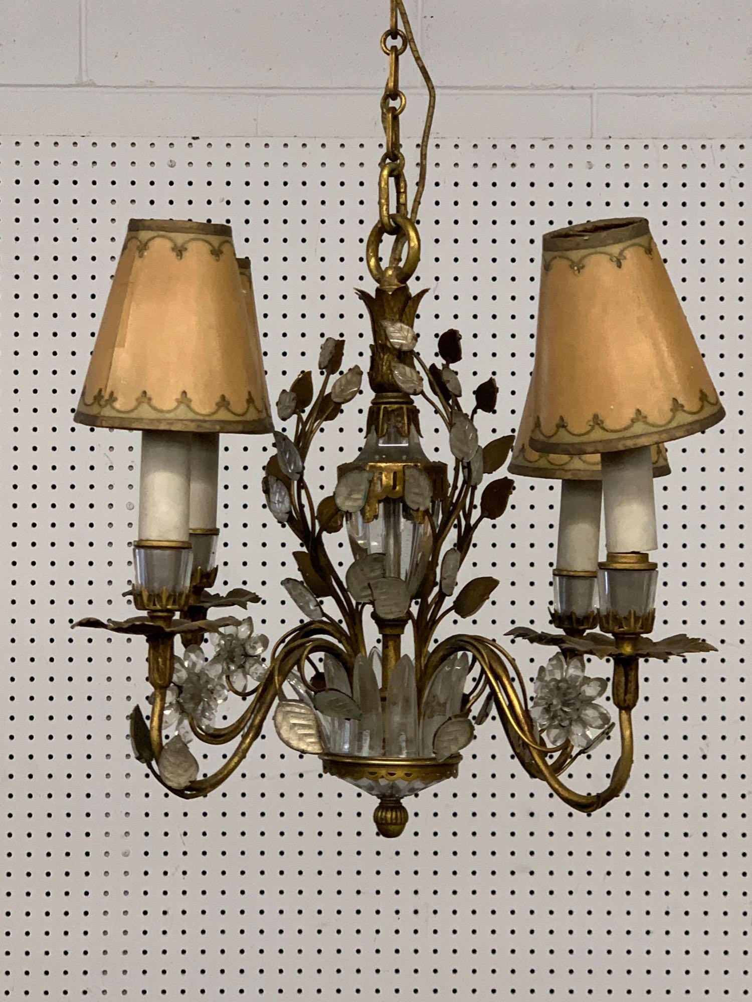 Bagues-style Gilt Metal and Crystal Chandelier: A chandelier by or in the style of Maison Bagues, having four gilt-metal arms with glass floral vine and blossom design, and glass mounts. Height: 20-1/2in to top of chain. 17-1/2 in diameter.