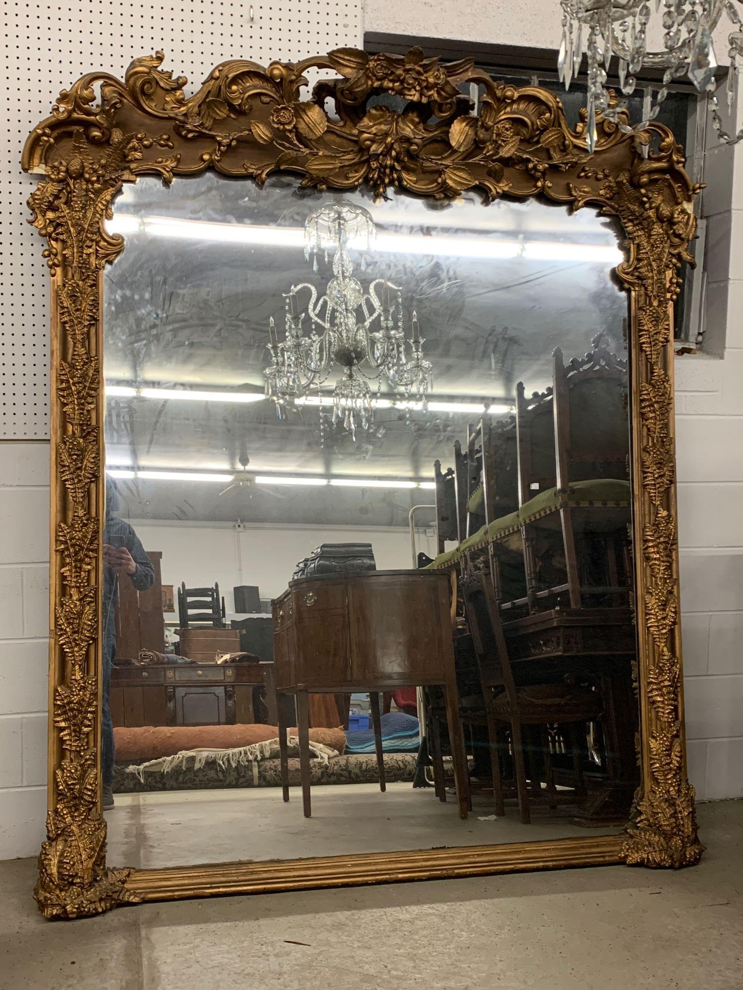 Large Ornate Victorian Gilt Pier Mirror: A large Victorian gilt-framed pier mirror having a pierced foliate crest and fern sides. 84 in tall x 71 in wide.