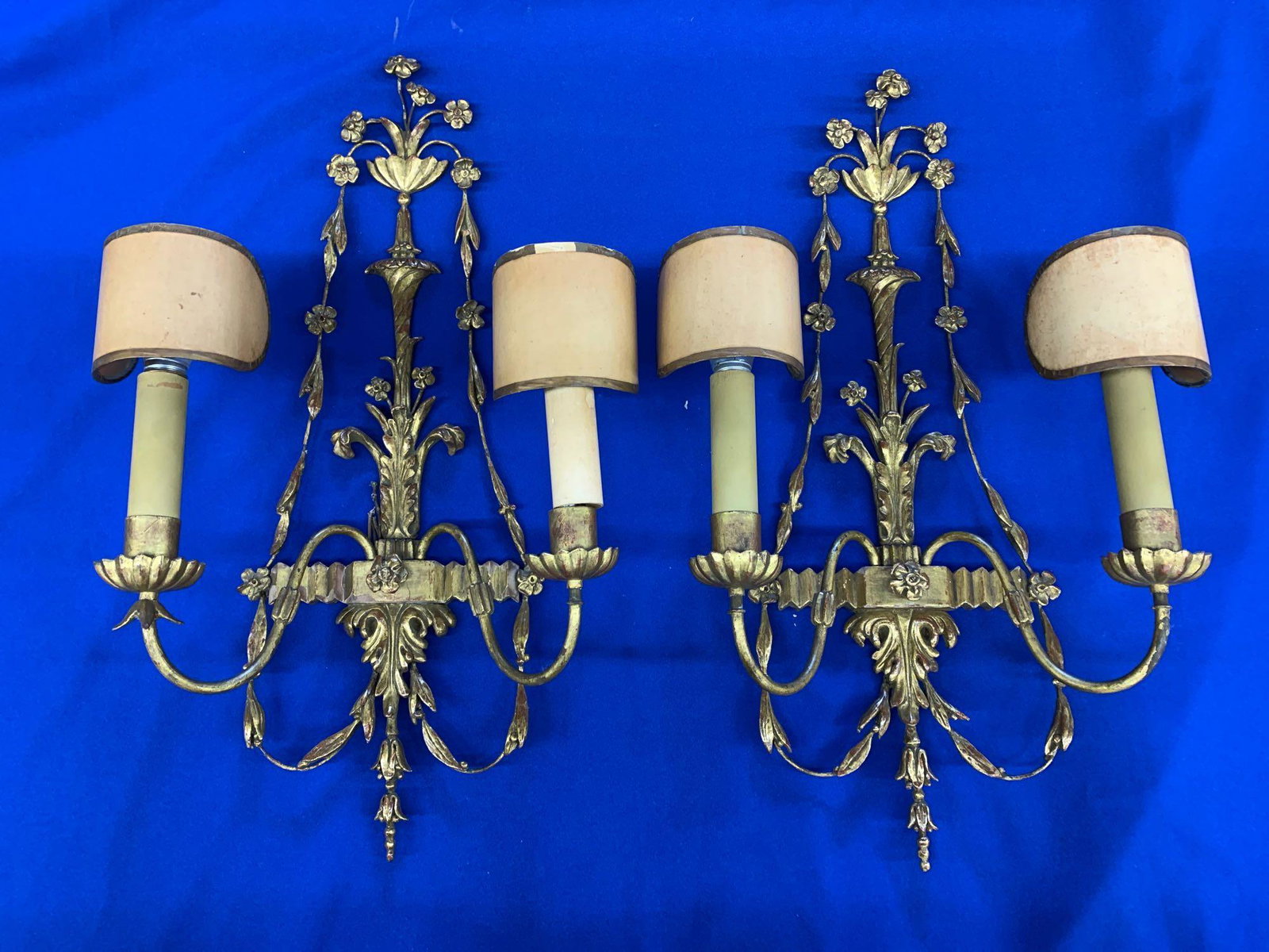 Pair of Louis XV-style Giltwood Wall Sconces: A pair of Louis XV-style giltwood and gesso wall sconces with swag decoration. 25 in tall x 13 in wide.