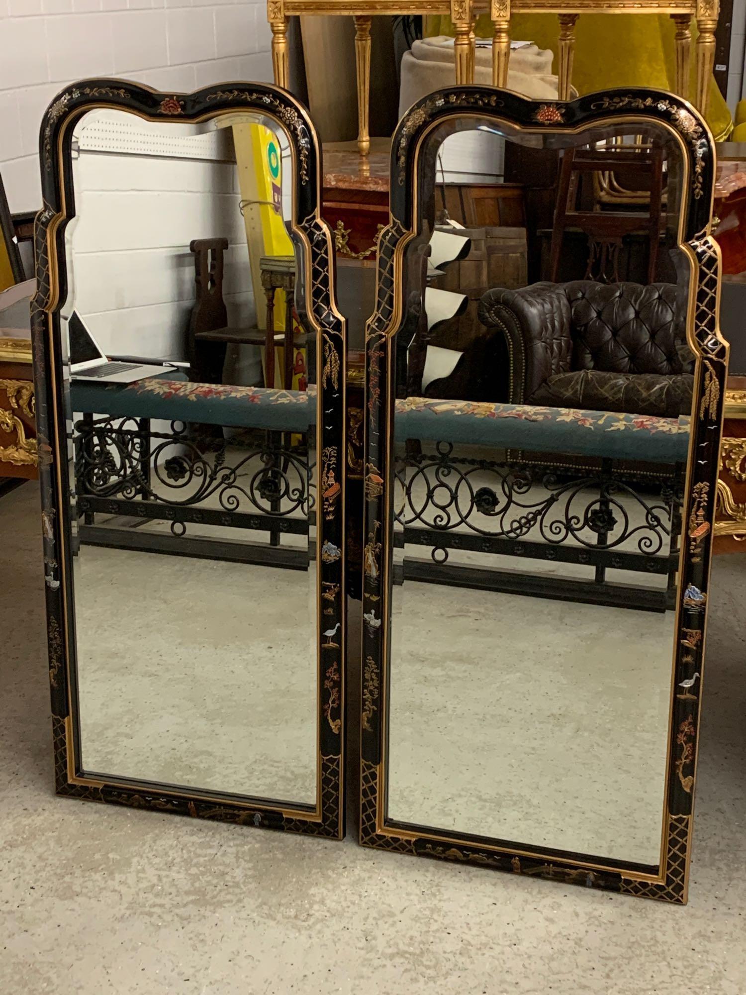 Pair of Henredon Chinoiserie Wall Mirrors: A pair of Henredon Queen Anne-style chinoiserie black lacquered wall mirrors with beveled glass mirror plates. Marked verso. Each is 47-1/2 in x 20-3/4 in wide.