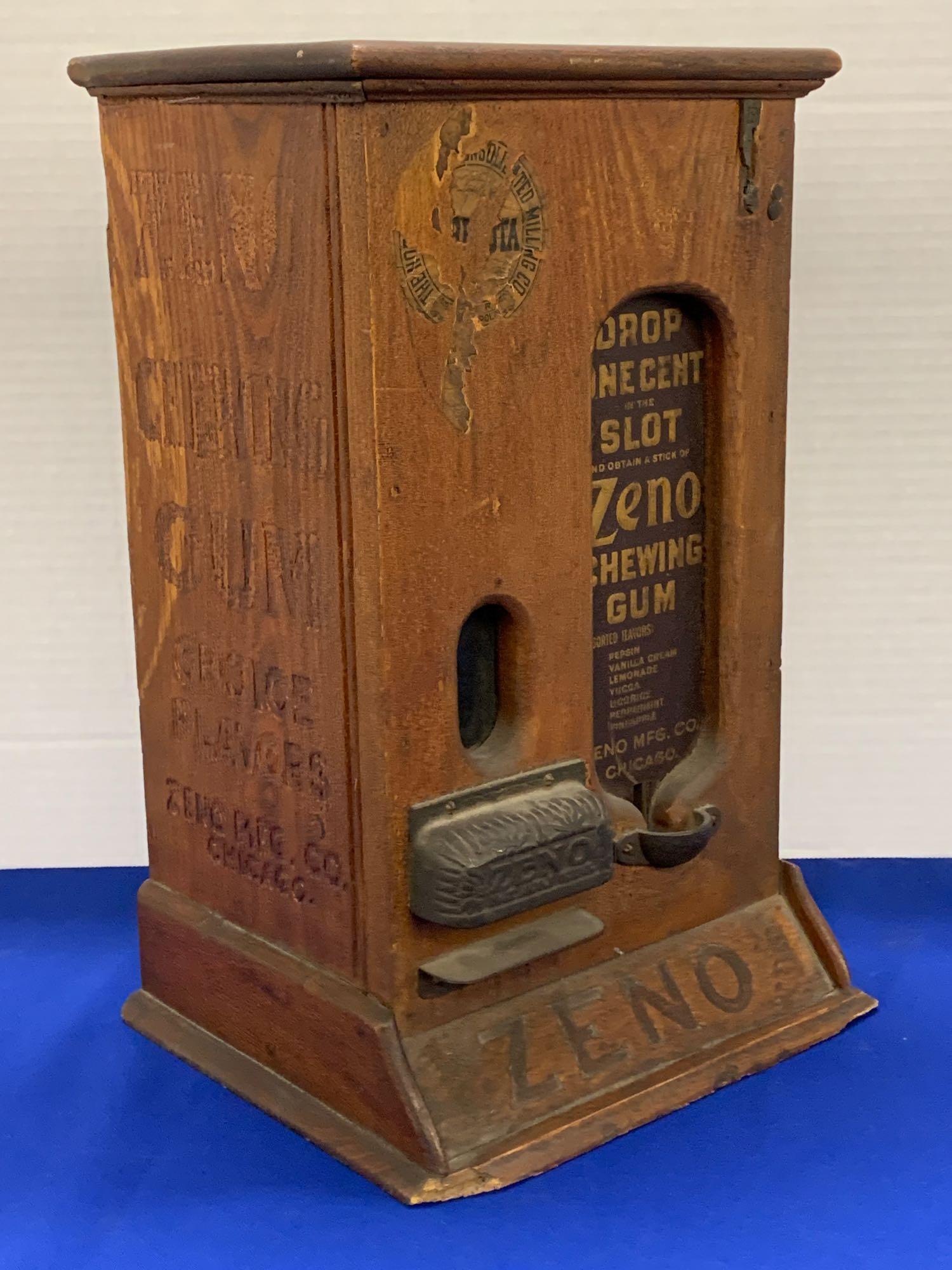 1-cent Wooden Zeno Stick Gum Vending Machine: An original coin-operated 1-cent Zeno stick gum vending machine. 16-1/2 in tall x 10-1/4 in wide x 9 in deep.