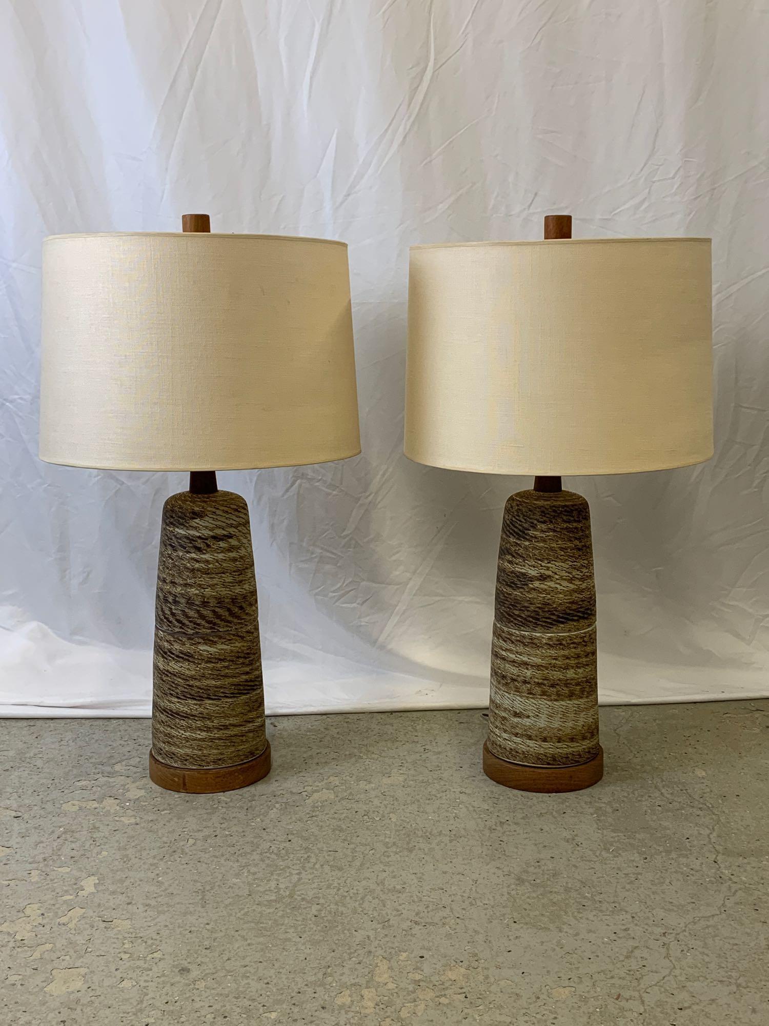 Pair of Modern Design Martz Ceramic Table Lamps: A pair of modern design stoneware table lamps attributed to Gordon and Jane Martz, of tapering form with textured earthtone design, and signature wood finials and bases. Unsigned. Each is 33-1/2 in ta