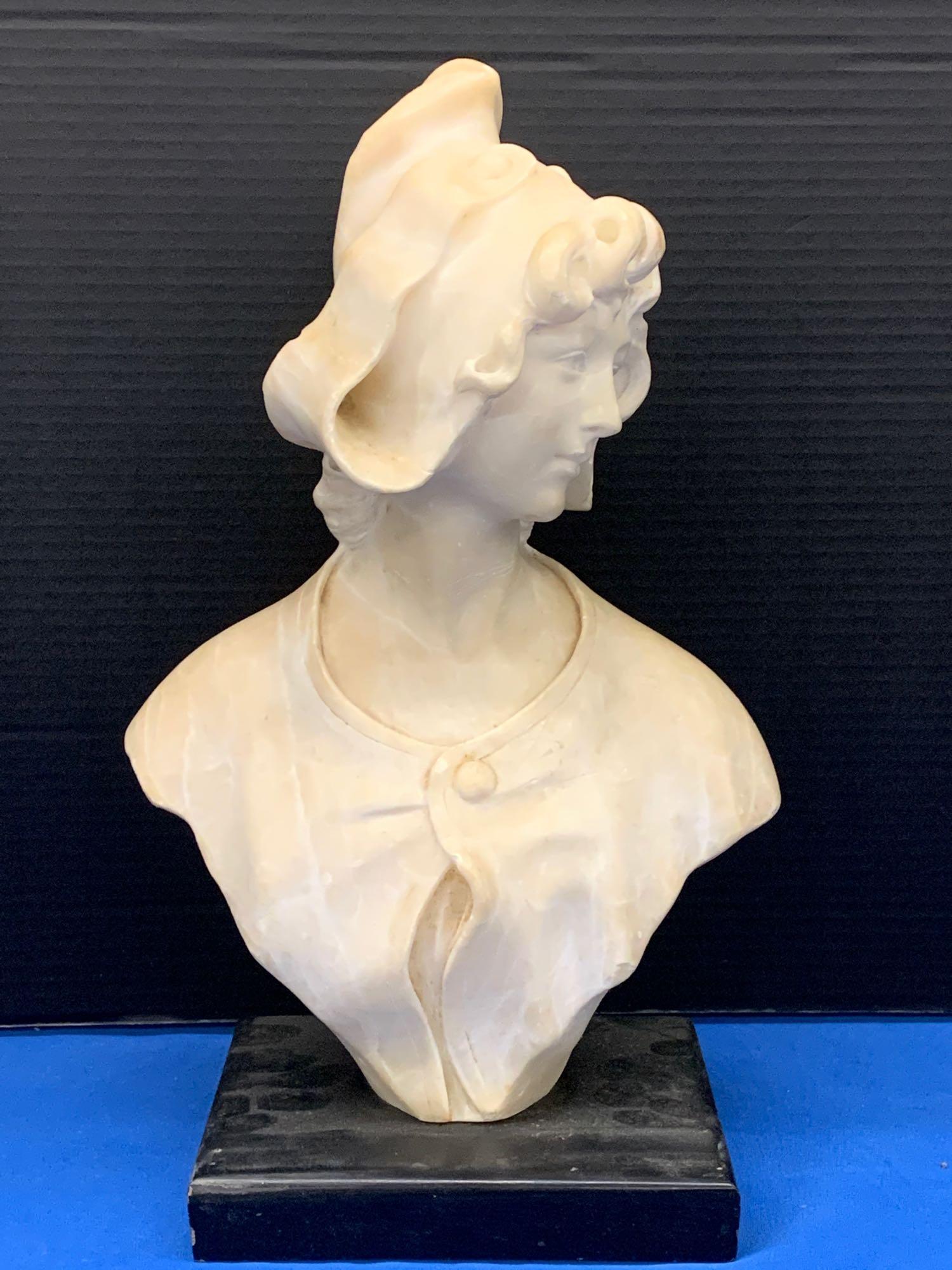 Carved Alabaster Bust of a Maiden: An unsigned carved alabaster sculptural bust of a maiden on a wooden base. Bust: 15in tall x 8-1/2in wide.