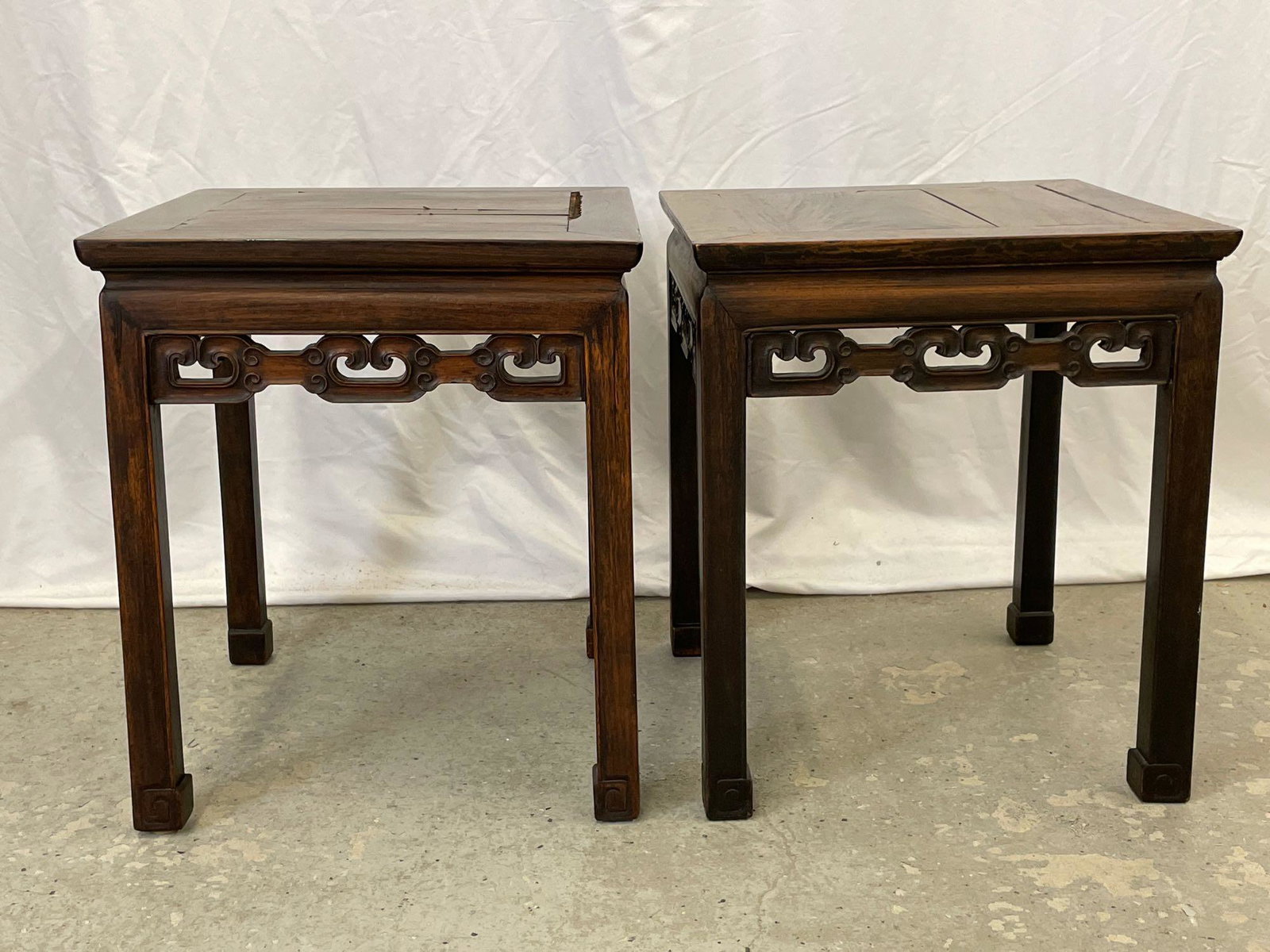 Pair of Chinese Carved Hardwood Tables: A pair of Chinese carved hardwood tables with pierced aprons. Each is 20-1/2in tall x 17-1/2in wide x 17-1/2in deep. Provenance: From the estate of Geraldine Shapiro, New York.