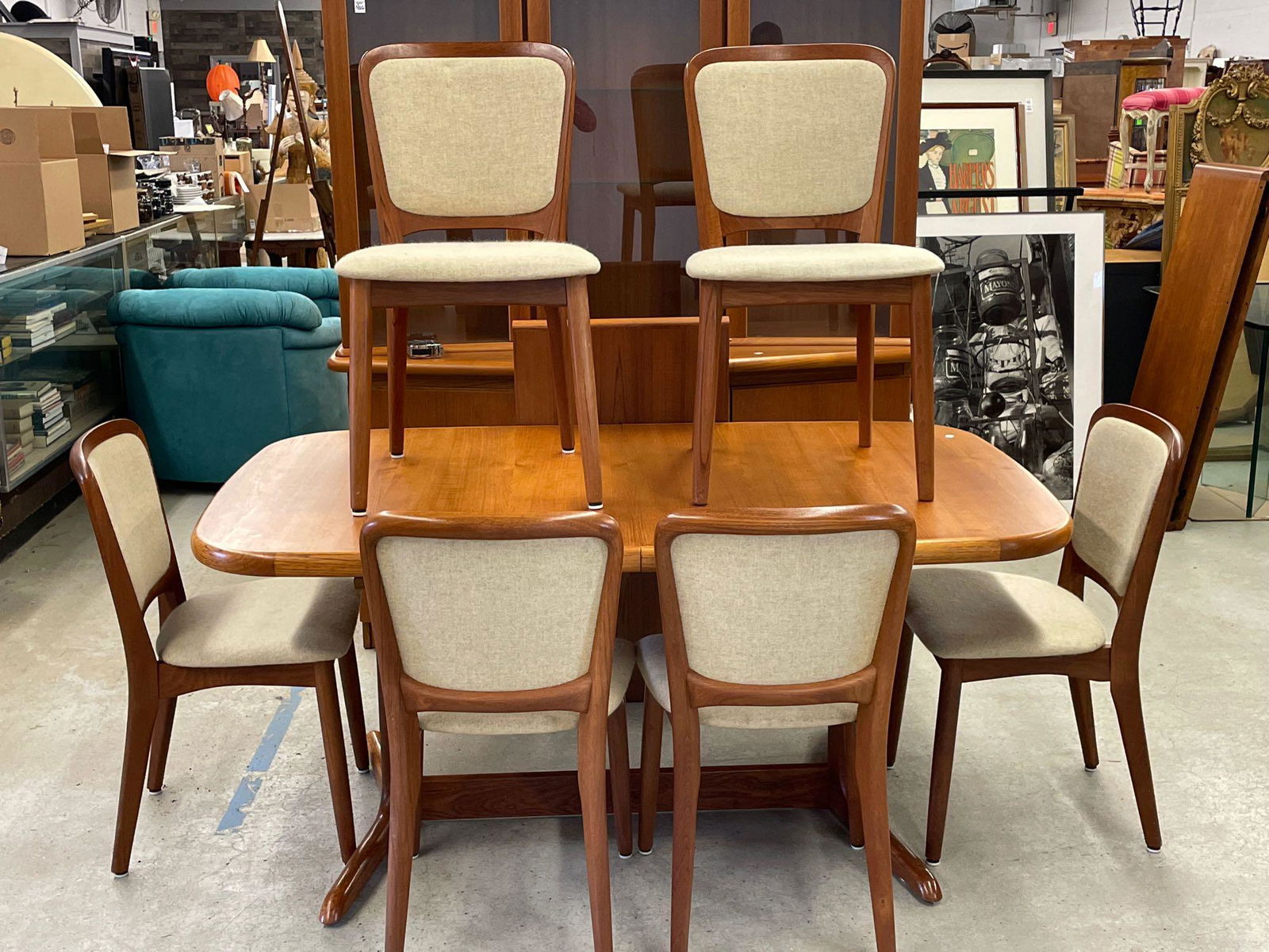 Danish Teak Dining Table and Chairs: A Danish teak extension dining table with six Koefoeds dining chairs. Table: 29in tall x 64in long x 38in wide. Table has one 19-1/2in leaf.