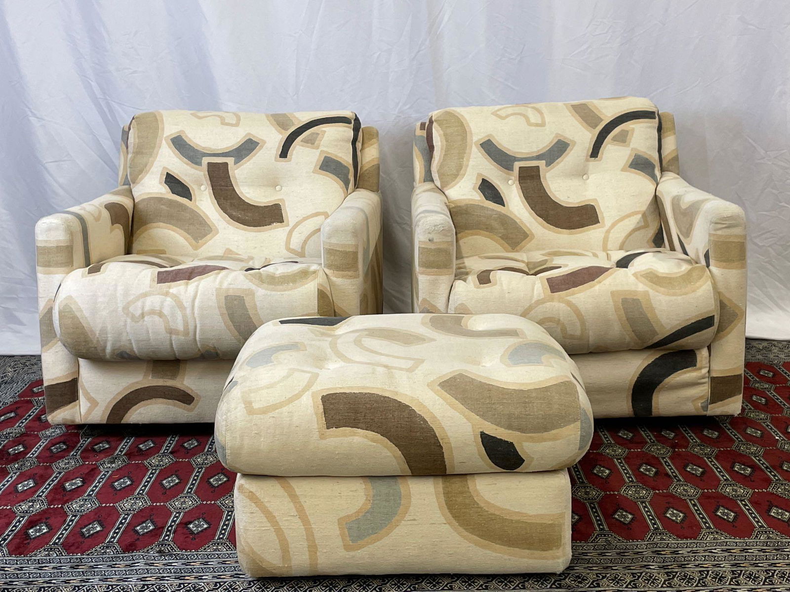 Pair of CY Mann Lounge Chairs and Ottoman: A pair of CY Mann modern design upholstered swivel club chairs and matching ottoman. Chairs: 27in tall x 29in wide x 33in deep. Provenance: From the estate of Geraldine Shapiro, New York.