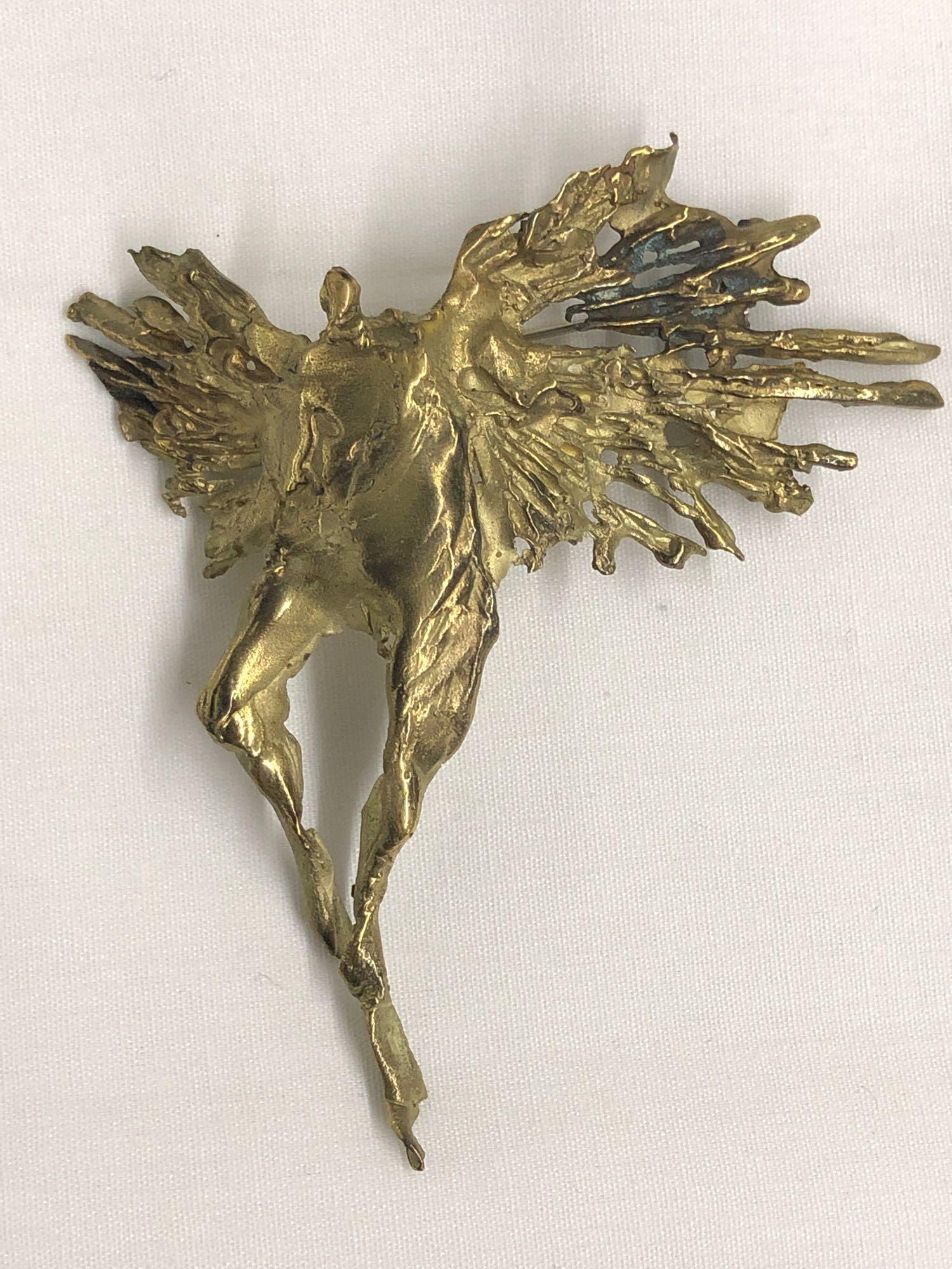 Judith Brown Sculptural Gold Brooch: A figural sculpted angel brooch from Judith Brown's "Flights Of Splendor" series. Marked JB 14K; however it tests as 10K. 3in x 3in. 13.24 dwt. Provenance: From the estate of Geraldine Shapiro, New Yo