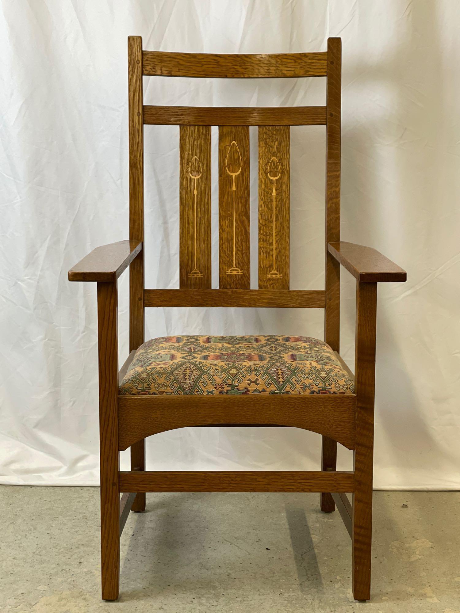 Stickley Inlaid Oak Armchair: A contemporary Stickley Arts & Crafts oak armchair with inlaid slatted back, branded mark, and metal tag. 44in tall x 24-3/4in wide x 20-1/2in deep.