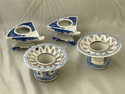 Four Japanese Sake Cup Stands: A grouping of four Japanese blue and white porcelain haidas or sake cup stands, to include a pair of fan form and a pair with pierced rims and chick design. Fan form: 2in tall x 3-1/2in wide x