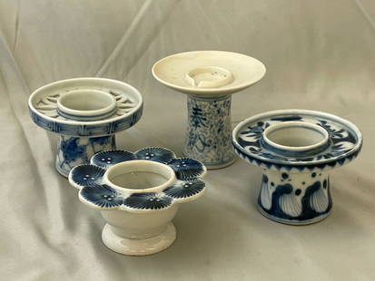 Four Japanese Sake Cup Stands: A grouping of four Japanese blue and white porcelain haidai or sake cup stands. Tallest: 3in tall x 3-1/2in diameter.