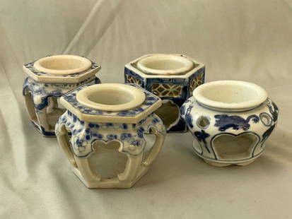 Four Japanese Sake Cup Stands: A grouping of four Japanese blue and white porcelain haidai or sake cup stands of varying forms. Tallest: 2-1/2in tall x 3-1/2in wide.