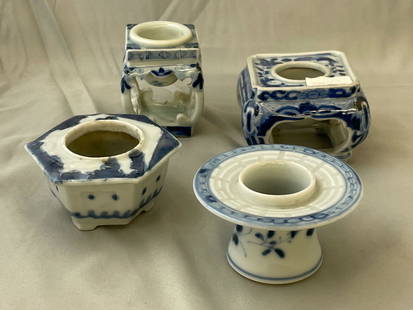 Four Japanese Sake Cup Stands: A grouping of four Japanese blue and white porcelain haidai or sake cup stands of varying forms. Tallest: 3in tall x 2-1/4in wide.