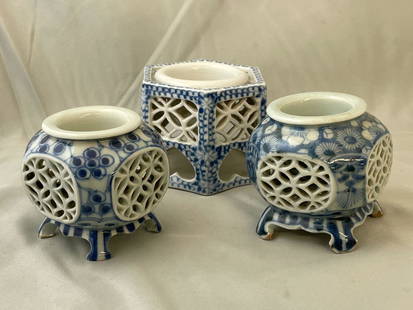 Three Japanese Sake Cup Stands: A grouping of three Japanese blue and white porcelain haidai or sake cup stands, each with pierced design. Largest: 2-3/4in tall x 3-3/4in wide.