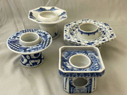 Four Japanese Sake Cup Stands: A grouping of four Japanese blue and white haidai or sake cup stands of varying forms. Tallest: 2-1/4in x 3-3/4in.