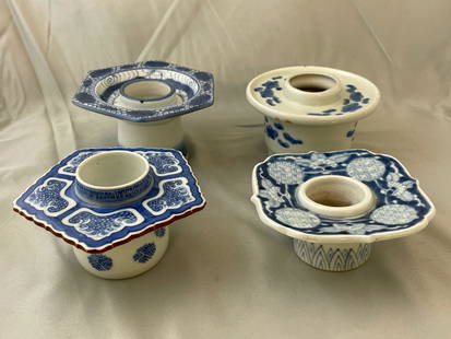 Four Japanese Sake Cup Stands: A grouping of four Japanese blue and white porcelain haidai or sake cup stands of varying forms. Tallest: 2-3/4in tall x 5in wide.