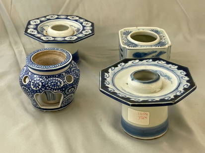 Four Japanese Sake Cup Stands: A grouping of four Japanese blue and white porcelain haidai or sake cup stands of varying forms. Tallest: 2-3/4in tall x 4-1/2in wide.