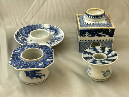 Four Japanese Sake Cup Stands: A grouping of four Japanese haidai or sake cup stands of varying forms; one with removable top. Tallest: 3-1/4in tall x 3in wide.