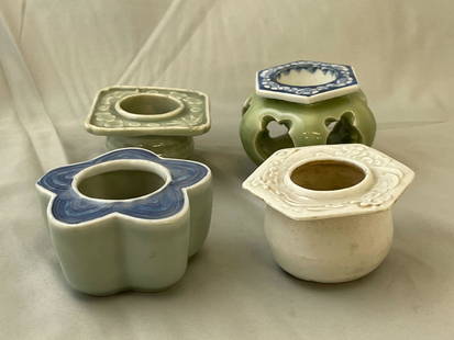 Four Japanese Sake Cup Stands: A grouping of four Japanese haidai or sake cup stands of varying forms. Tallest: 2-1/2in tall x 3-1/2in wide.