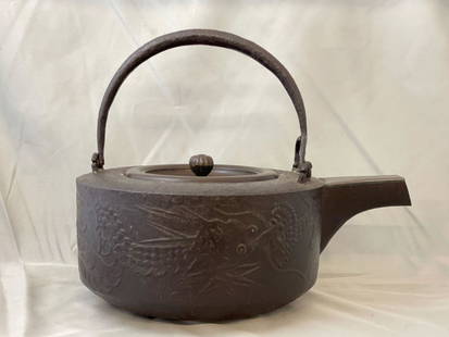 Japanese Cast Iron Sake Kettle: A Japanese cast iron sake kettle with dragon decoration. Signed under lid. 8in tall x 9-1/2in wide.