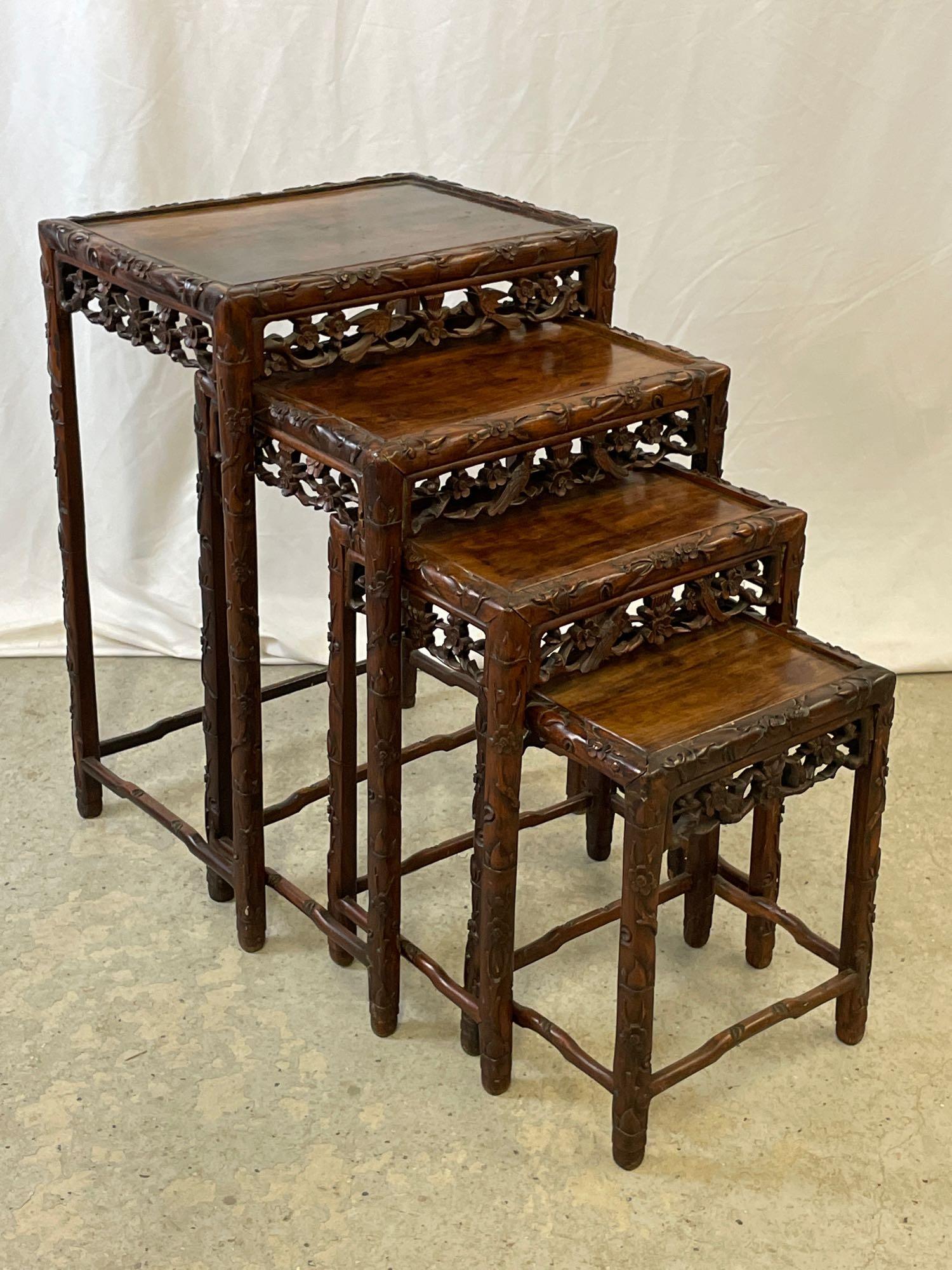 Nest of Four Chinese Carved Hardwood Stands: A nest of four Chinese carved hardwood stands with pierced foliate and bird aprons. Largest: 28in tall x 19-1/2in wide x 14in deep.