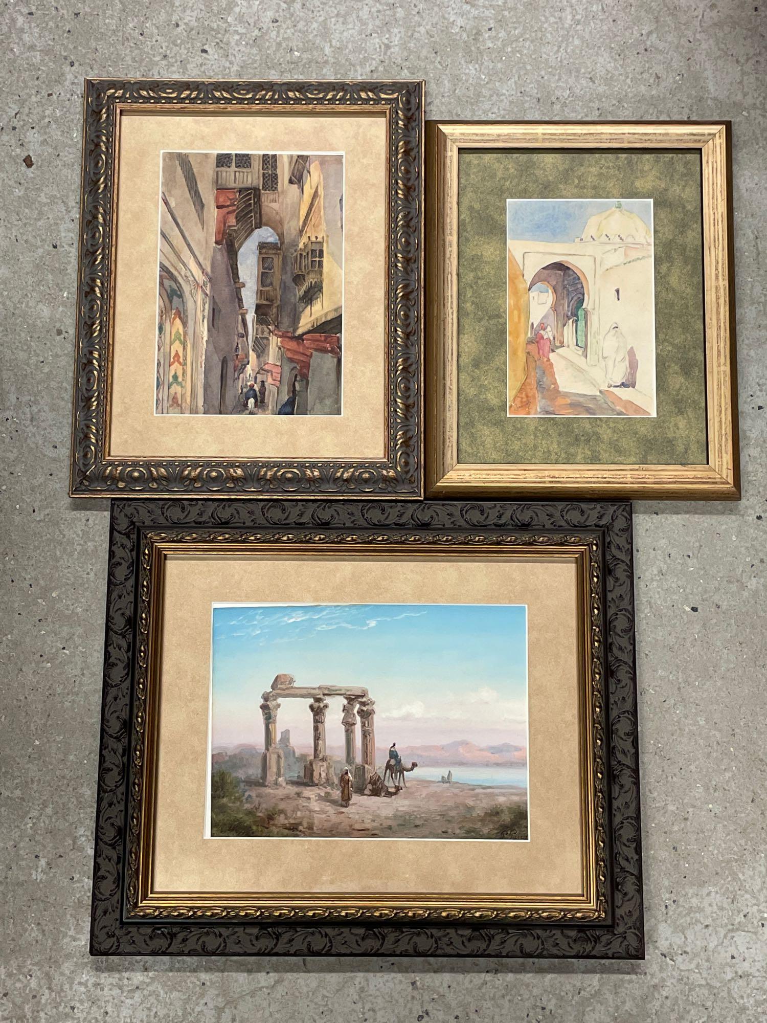 Three Orientalist School Watercolor Landscapes: A grouping of three Orientalist school watercolor landscapes to include a Paul Pascal (French, 1832-1903) watercolor depicting camels and riders in a landscape with ruins; a watercolor on paper landsc