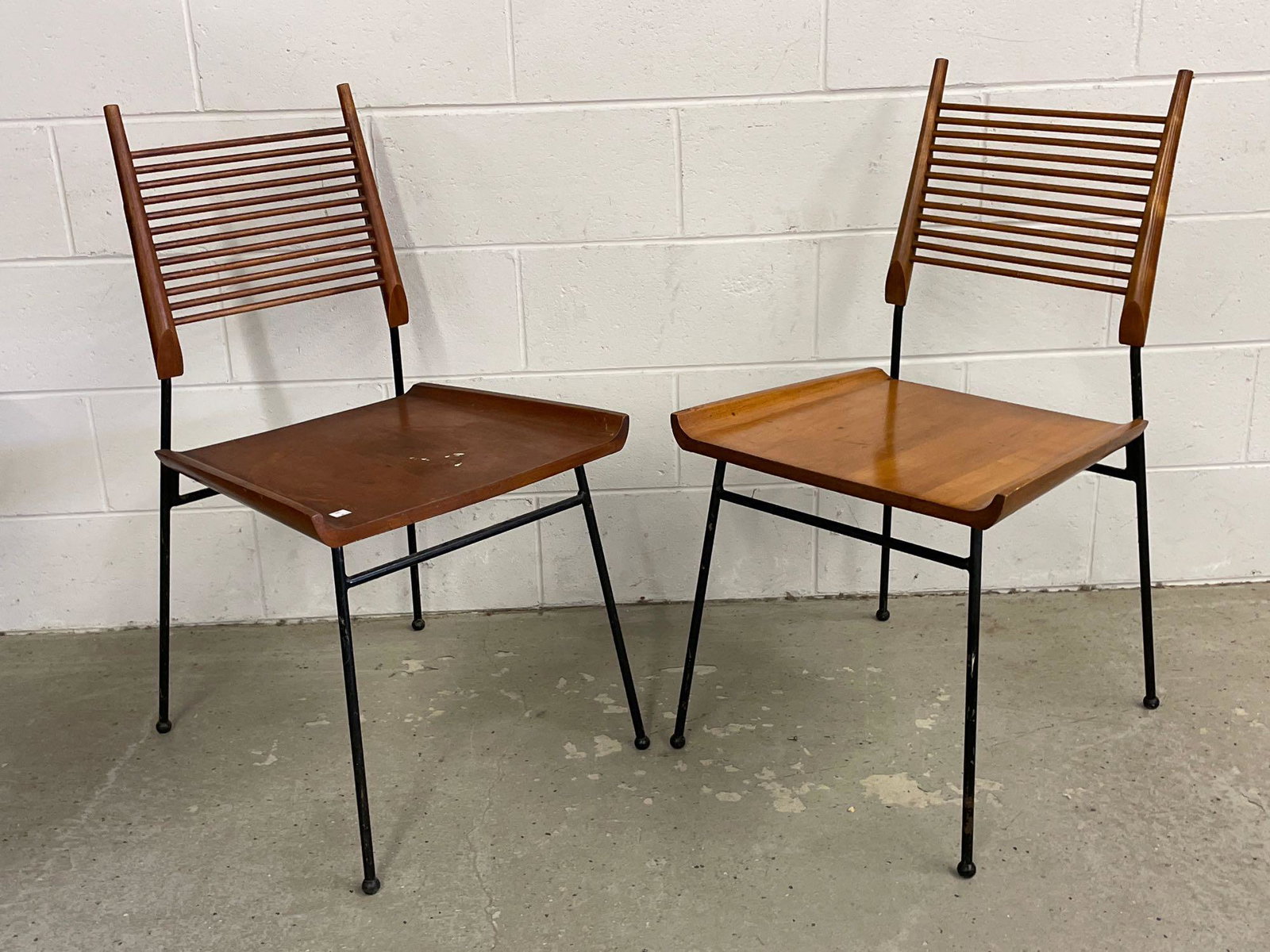 Pair of Paul McCobb Shovel Chairs: A pair of Paul McCobb iron-framed shovel chairs with slatted backs. Unmarked. Each: 34in tall x 18-1/4in wide x 19in deep.