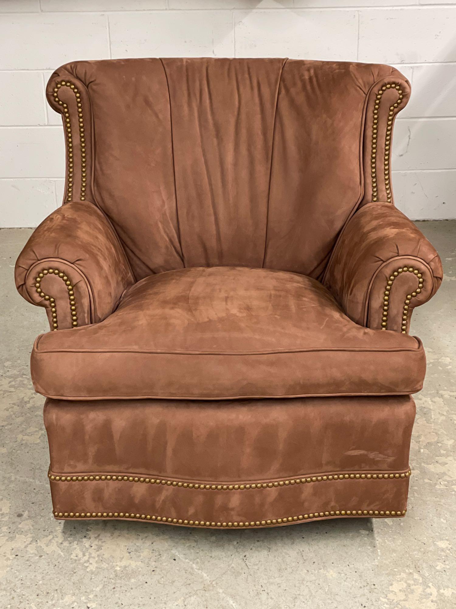 Hancock & Moore Decorator Lounge Chair: A Hancock & Moore brass-tacked suede-upholstered lounge chair with swivel and rocking action. 34in tall x 34in wide x 27in deep.