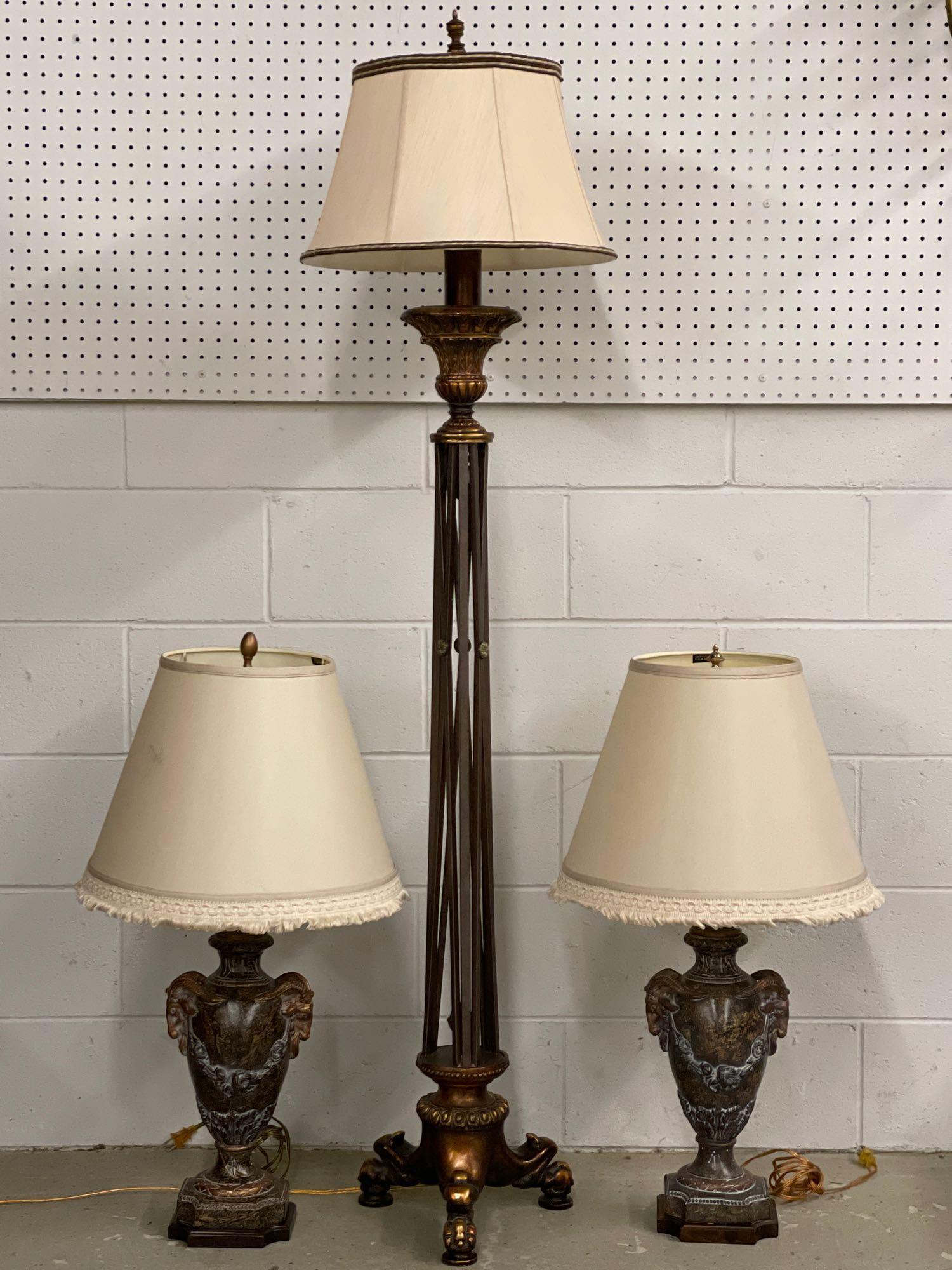 Three Pieces of Decorator Lighting: A grouping of three pieces of decorator lighting to include a pair of Frederick Cooper ram's-head table lamps, and a regency-style floor lamp, possibly by Maitland Smith. Floor lamp: 65in tall.