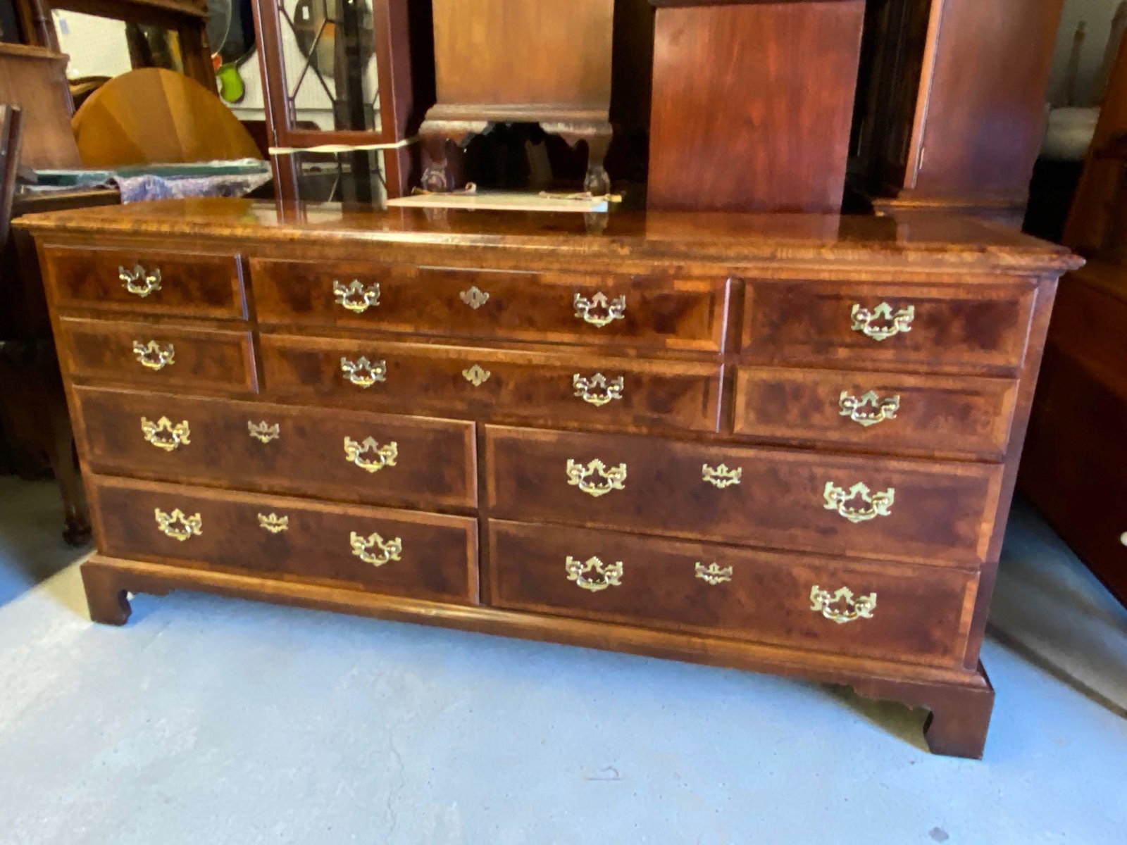 Henredon Mahogany Triple Dresser: An Aston Court by Henredon mahogany triple dresser with banded top and drawer fronts. 34in tall x 70in wide x 20in deep.
