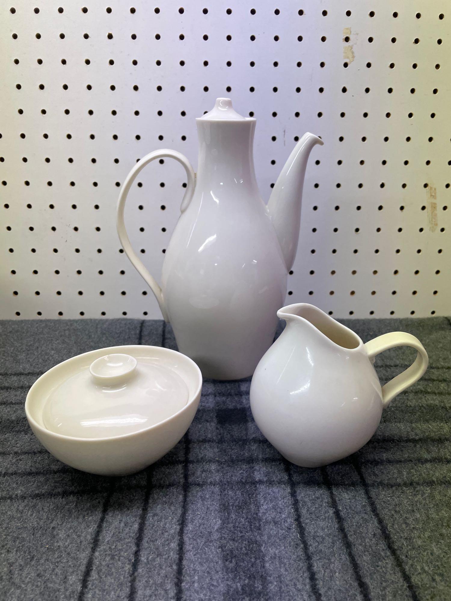 Eva Zeisel White Castleton China Grouping #2: (D) Vintage Eva Zeisel museum white Castleton China ceramic coffee set. Large pitcher with lid: 5" Diameter x 9 1/2" Tall Sugar bowl: 4 3/4" Diameter x 3" Tall Creamer pitcher: 4" Diameter x 4 1/2" Ta