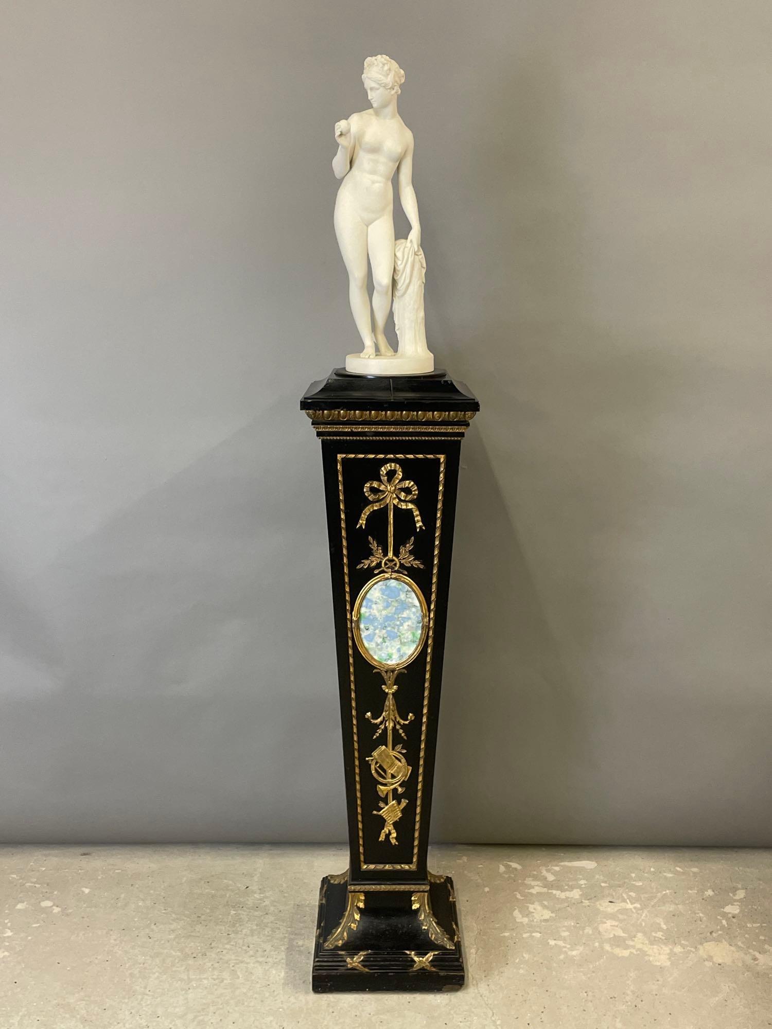 Gustavsberg Parian Sculpture on Pedestal: A Gustavsberg Parian porcelain sculpture of Eve holding an apple. Raised on an ebonized and gilt adorned pedestal. Sculpture is affixed to rotating pedestal insert. 70 in tall x 12-1/2 in wide x 12-1/