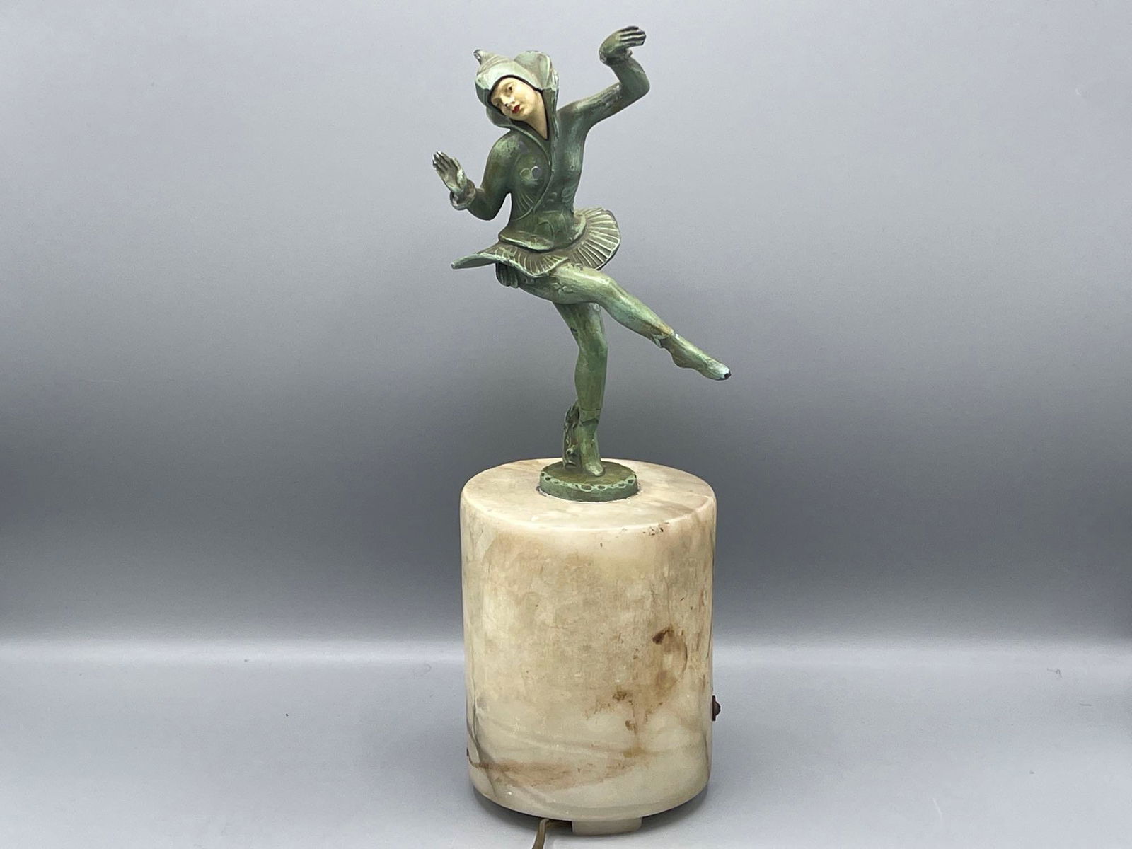 After Gustav Schmidt Cassel Bronze: A painted bronze sculpture after Gustav Schmidt Cassel (1862-1954) depicting a dancer resting on onyx lamp base. 13 in tall x 4-1/2 in diameter.