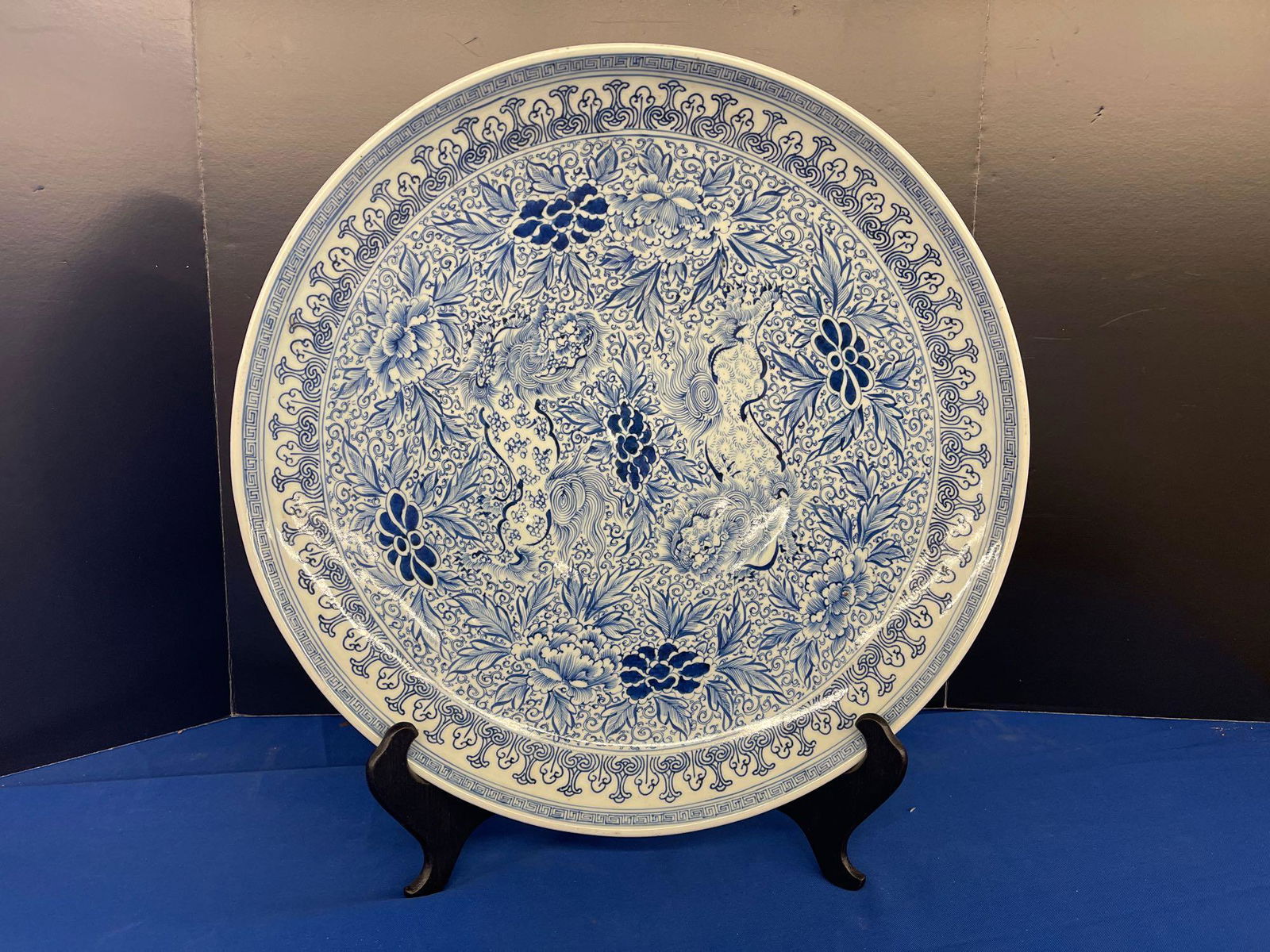 Large Chinese Porcelain Charger: A very large Chinese porcelain blue and white charger having hand painted tiger design, resting on stand. Marked on back. 18 in diameter. With protective blue box.