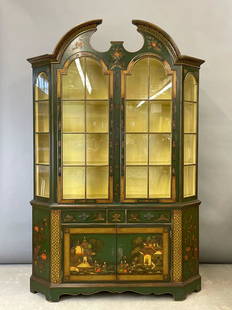 Schmieg & Kotzian Chinoiserie China Cabinet: A Schmieg & Kotzian one-piece chinoiserie china cabinet having a paned glass door top with shelved interior, over a base with two drawers over two cupboard doors. With a chinoiserie decoration on gree