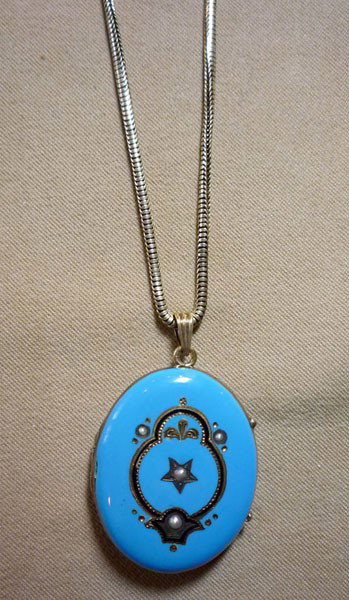 Enameled Locket: Enameled locket. Early gold-filled chain supporting a blue enameled locket with inlaid seed pearls and black enamel. $10-30/10