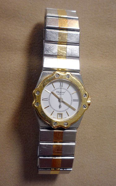 Lady's Chopard Wristwatch: Lady's Chopard wrist watch in stainless steel with 18K yg face and band accents. Marked "SM30705 8024".