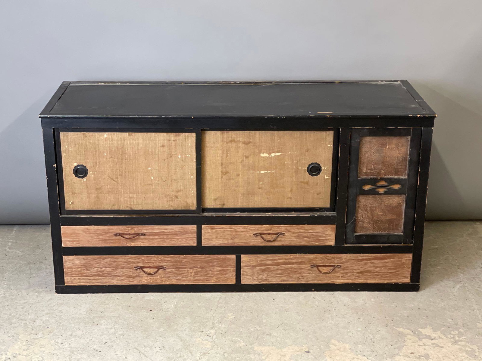 Japanese Tansu Cabinet: A Japanese tansu cabinet with various compartments and drawers. 23in tall x 49-1/2in wide x 16-1/4in deep.