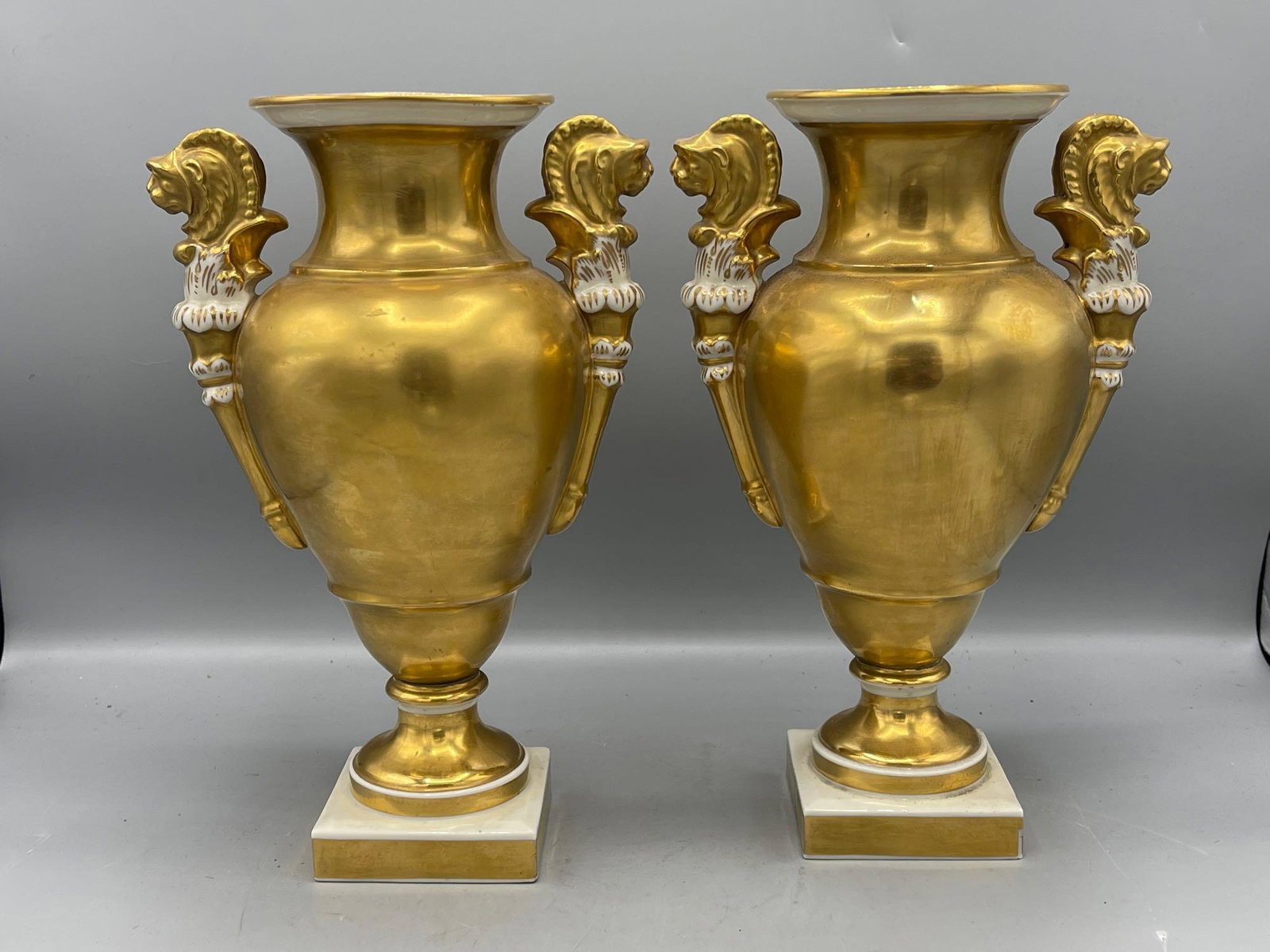 Pair of Capodimonte Porcelain Vases: A pair of Capodimonte porcelain vases with gilt glaze and creature-form handles. Marked on base. 11in tall.