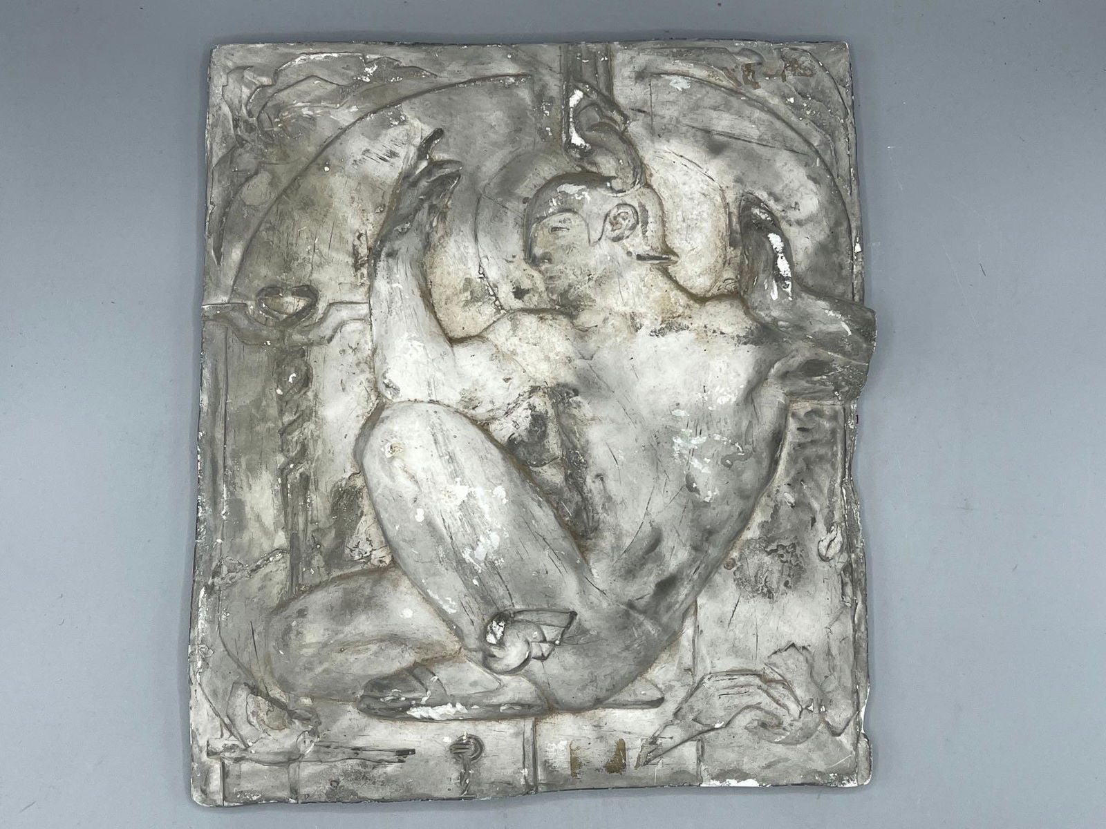 Ceramic Plaque of Hermes: A ceramic plaque depicting Hermes, the God of speed, with winged sandals and helmet. 12-1/2in tall x 11in wide.