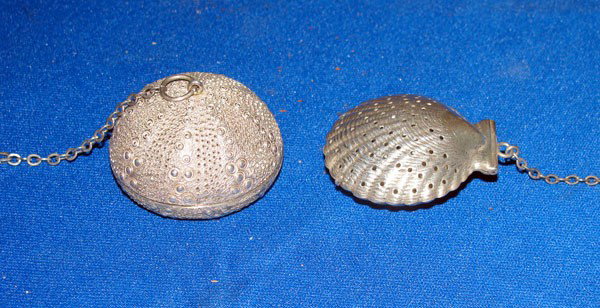Lot of Two Tea Ball Infusers.: 2 tea ball infusers. One Gorham sterling scallop shell infuser (1-¾" x 1-½" x ¾"). One "Janna" Mexico Sterling sea urchin infuser (1 ¾" x 1"). 2.40 ozt total.