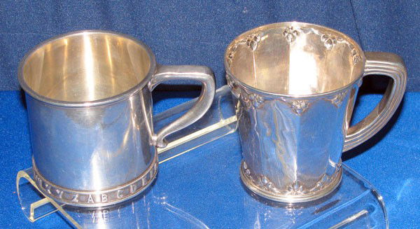 2 sterling mugs: A Gorham sterling mug w/ relief alphabet around the base, 2 3/4" high, 4 1/4" wide 3" diam. A Simons & Brothers (Philadelphia, PA) sterling mug with embossed floral pattern top and bottom, 3" high, 4"