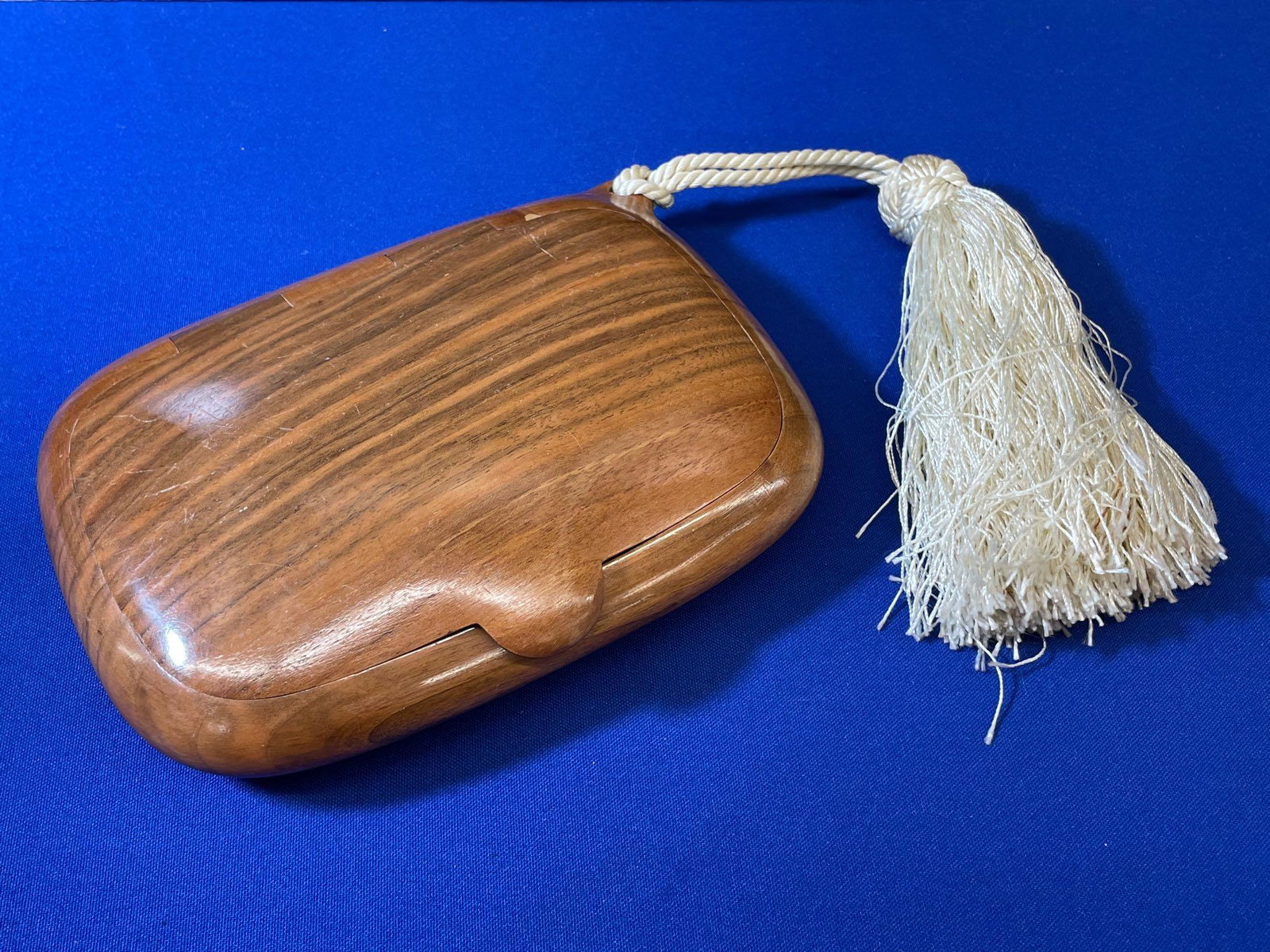 Emanuele Pantanella for Fendi Evening Trousse: An Emanuele Pantanella for Fendi wooden evening trousse or clutch with a hinged case and ivory silk tassel. Fendi monogram on interior. Marked 0071 on underside. 7-1/2in x 5-3/4in.
