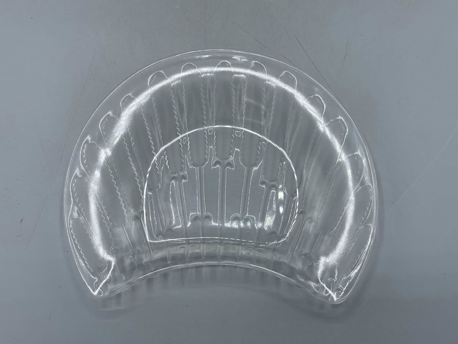 14 Lalique Chardon Plates: A set of 14 Lalique glass "Chardon" plates of crescent shape, with frosted wheat decoration. Signed "Lalique France" edges. 8in wide.