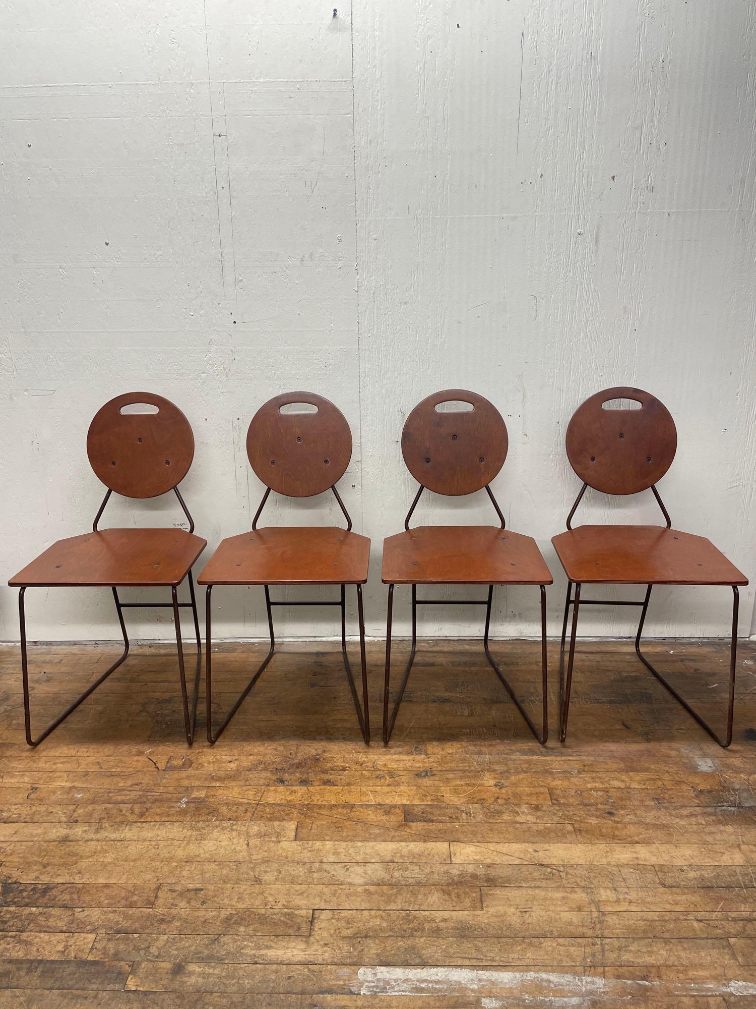 Four Vintage Geometric Ply Chairs: (P3) A set of 4 atomic age plywood and iron dining chairs with a geometric design. Cutouts on the circular seatbacks serve as convenient handles. The chairs have been professionally refinished on the