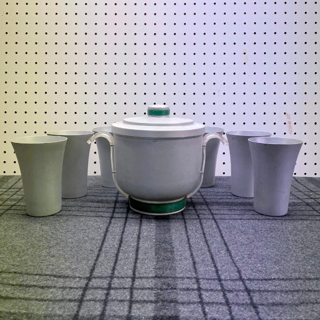 Art Deco Spun Aluminum Drink Set: (B) A vintage spun aluminum drink set including 7 cups and a matching ice bucket. The ice bucket has lucite handles and measures 7-1/2in tall x 7in diameter (not including handles). Global shipping av