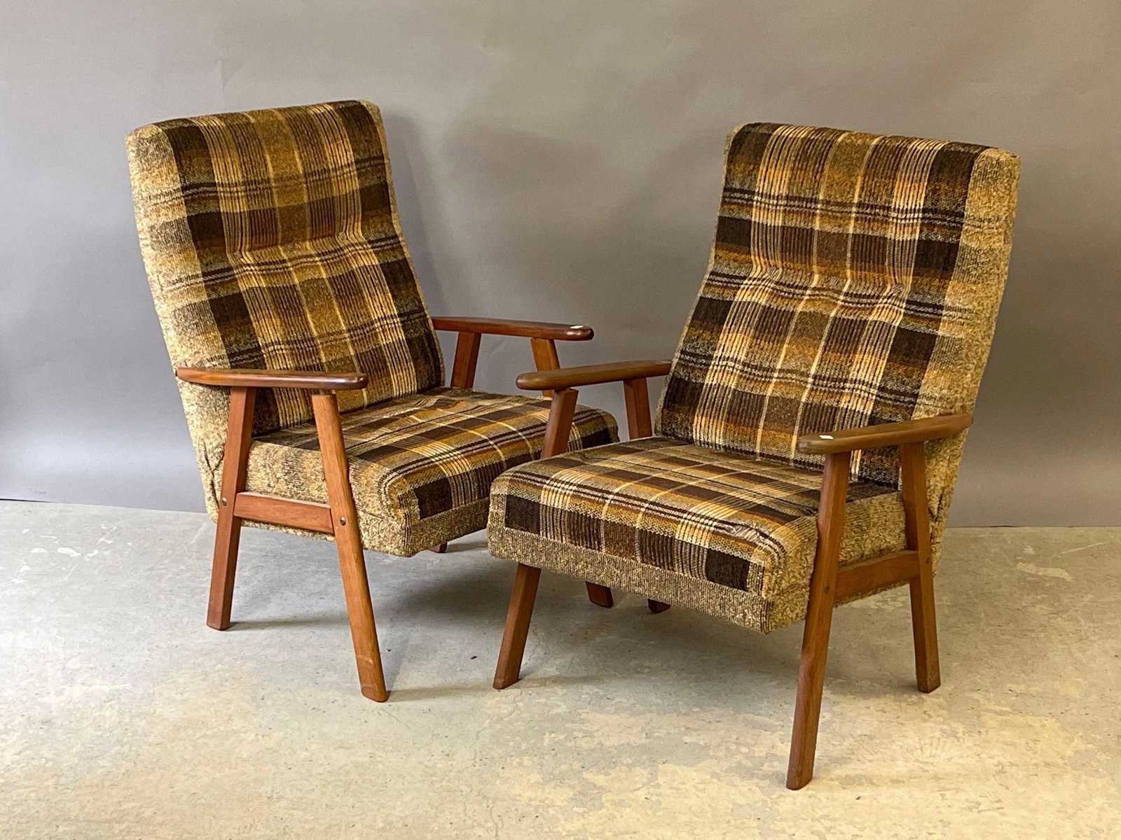 Pair of Teak-framed Lounge Chairs: A pair of teak-framed lounge chairs with plaid upholstery. Unmarked. Each: 36in tall x 25-1/2in wide x 24in deep. | Local and NYC curbside delivery details and international third-party shipper recomm