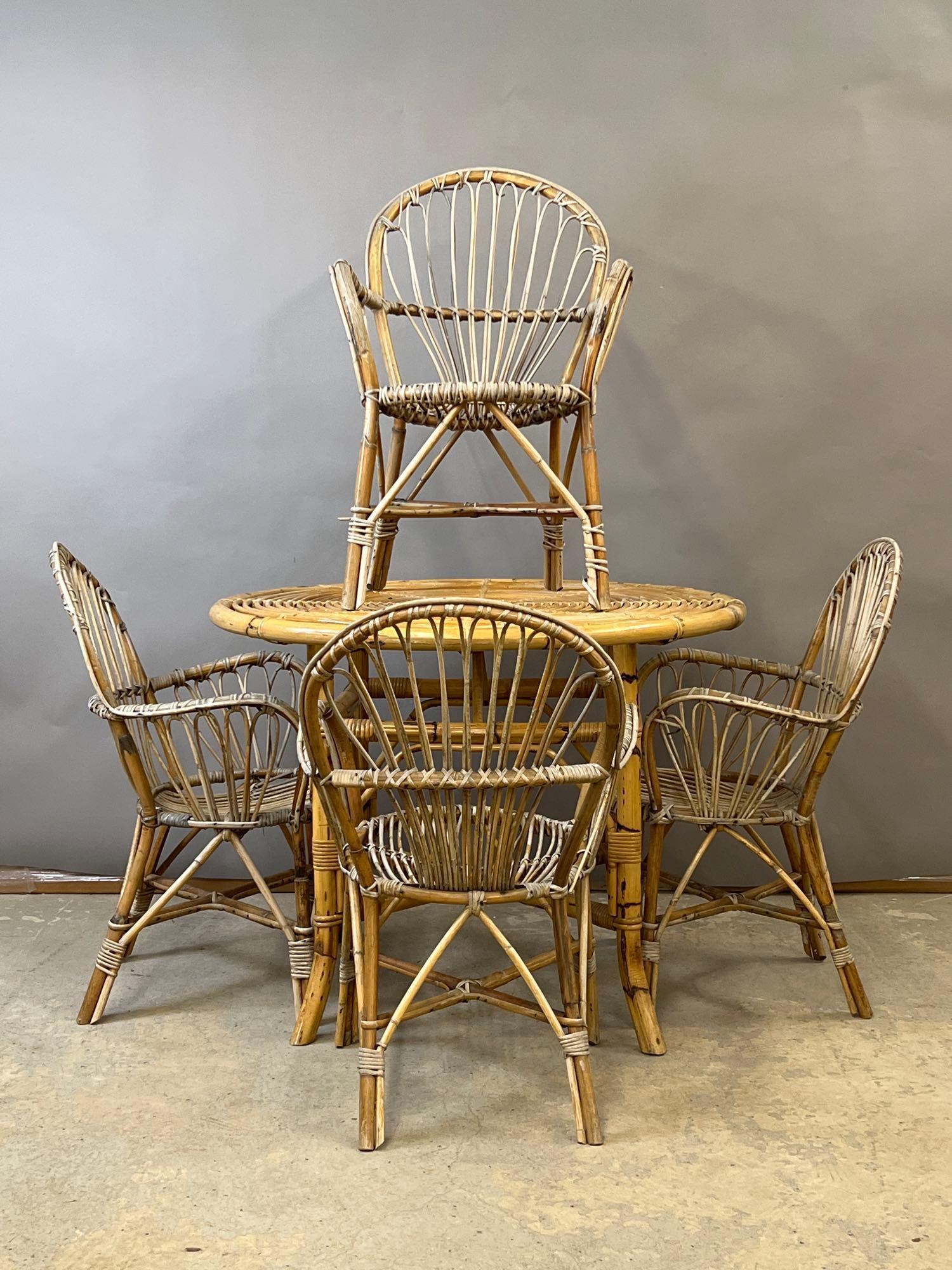 Rattan Table and Four Chairs: A bamboo and rattan circular dining table and four chairs in the manner of Franco Albini. Table: 28-1/2in tall x 40in diameter. | Local and NYC curbside delivery details and international third-party