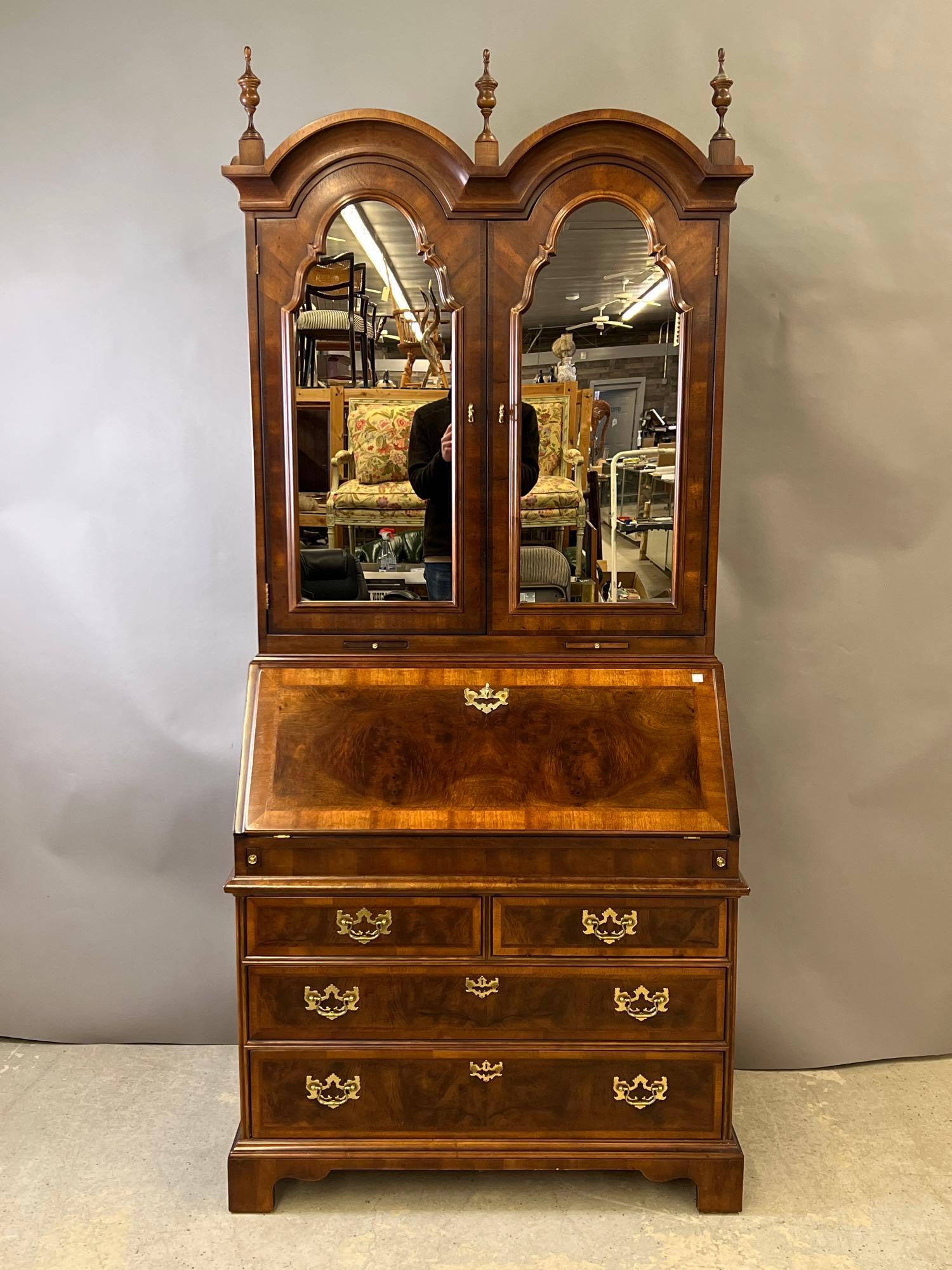 Henredon Aston Court Secretary Desk: A Georgian-style banded mahogany bonnet-top secretary desk by Henredon with mirrored doors on the upper case. One piece. 86in tall x 39in wide x 22in deep. | Local and NYC curbside delivery details an