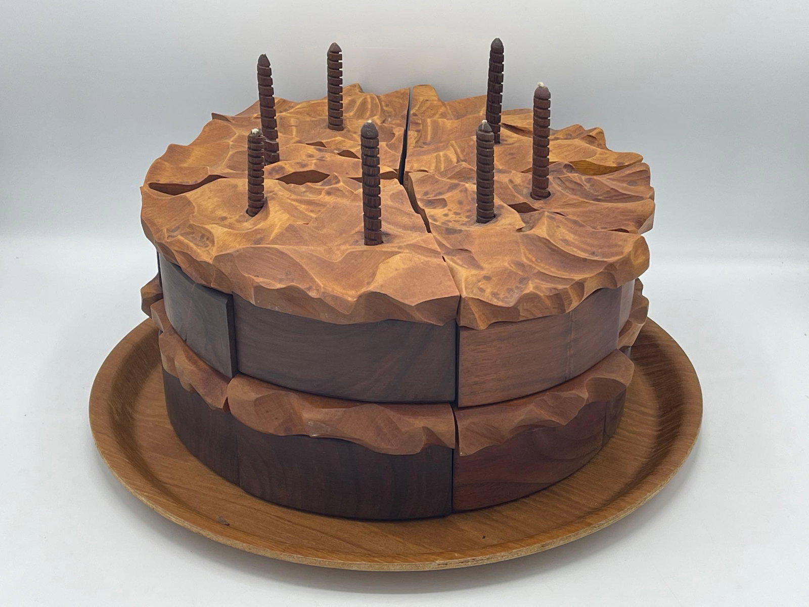 Artisan Wood Puzzle Cake: A unique artisan four-layer wooden birthday cake with turned wooden candles, resting on wood plate. Illegibly signed and dated. 7in tall x 12in wide. | Local and NYC curbside delivery details and inte